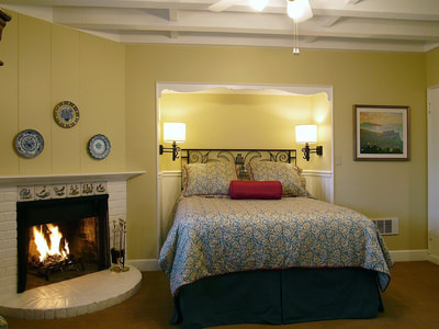 Normandy Inn Cottages Bedroom with Fireplace